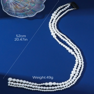 Three-layer pearl hair chain accessory with 52cm length and 49g weight on blue background