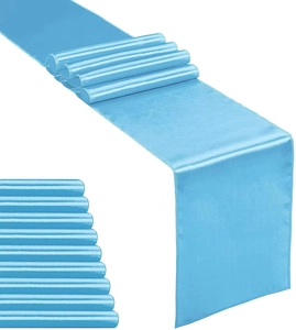 Close-up of bright blue satin table runner with high gloss finish and soft drapery texture