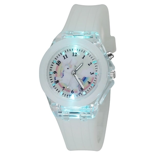 Close-up of glowing LED unicorn watch with colorful rainbow dial and white silicone strap