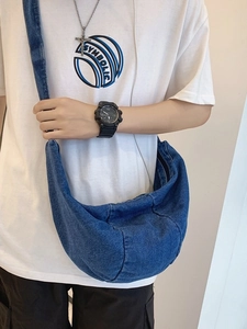 Unisex large denim crossbody bag with crescent moon shape and wide shoulder strap