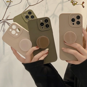 Handheld iPhone cases in earth tones with matching round pop-out grip stands
