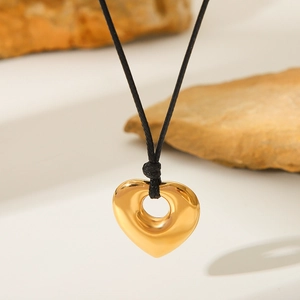 Minimalist heart-shaped gold pendant necklace featuring black wax cord and openwork design