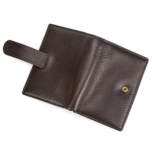 Detail of dark brown pebble grain leather wallet with golden snap button closure