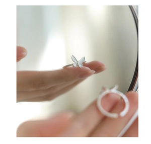 Macro detail of a 925 silver butterfly ring with adjustable band and polished finish