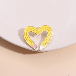 Creative twisted heart-shaped pencil enamel pin featuring Make More Art slogan