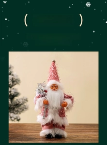 Detail of pink sequin Santa Claus figurine with plush beard and sparkling fabric hat