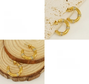 Close-up of gold bamboo C-hoop earrings with rhinestone inlay and polished finish