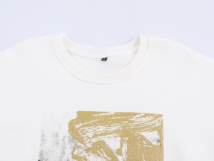 Detail of white cotton T-shirt neckline with metallic paint print and S size label