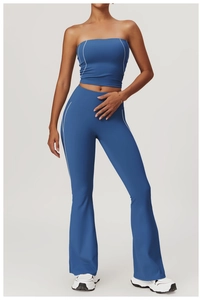 Detail view of royal blue yoga set featuring contrasting side stripes and flared hem design