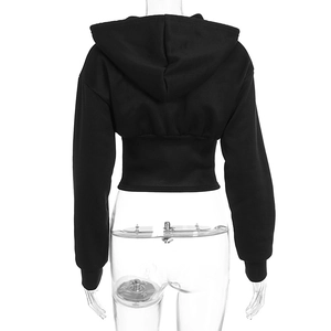 Detail view of the drawstring hood and ribbed waist on this black cropped sports hoodie