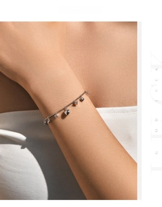 Detailed close-up of s925 silver beaded bracelet with heart charms and star pendants