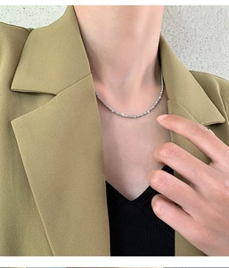 Detail of shimmering silver star necklace on neck with elegant sparkling starburst effect