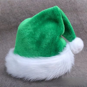 Detail of green plush Christmas hat with fluffy white faux fur trim and pom-pom