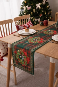 Detailed view of Merry Christmas table runner with wreath on festive wooden table