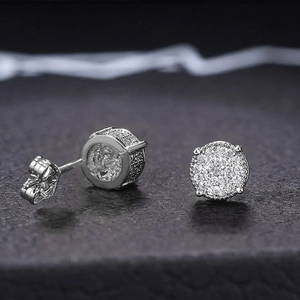 Macro shot of silver hip-hop earrings with micro-paved cubic zirconia and butterfly backings