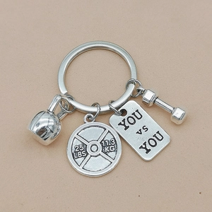 Detailed silver fitness keychain featuring mini kettlebell, dumbbell and barbell plate charms