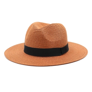 Close-up of brown straw fedora with black ribbon showing detailed woven texture and brim