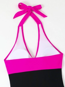 Detail of contrast color halter neck swimsuit with adjustable bow tie and padded cups