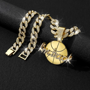Detail of gold Cuban link chain and basketball pendant with iced-out Kobe lettering