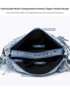 Detail view of denim crossbody bag interior showing multiple zipper compartments for storage