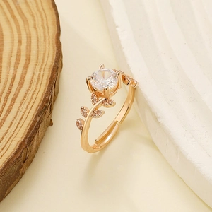 Close-up of rose gold laurel branch ring with brilliant cut moissanite and pave leaf detail