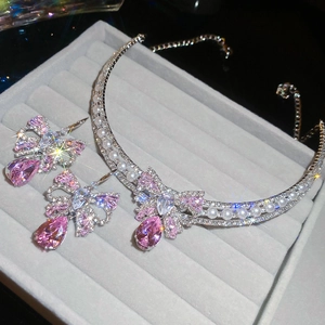 Detail of pink crystal butterfly jewelry set with necklace and earrings in silver finish