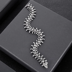 Gothic vintage stainless steel spine bone bracelet displayed on a black textured box