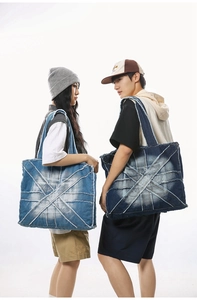 Fashionable denim tote bag shown on models highlighting large capacity and patchwork design