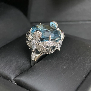 Exaggerated 18k silver plated floral ring with oversized blue gemstone in a gift box