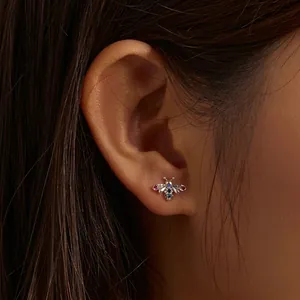 Delicate 925 sterling silver bee stud earring with colorful crystals on model's ear