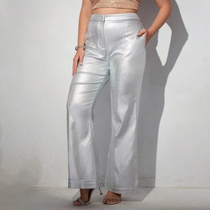 Detail of silver metallic wide-leg trousers showing shimmering fabric and high-waist design