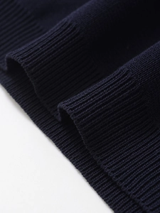 Detailed close-up showing the premium ribbed cuffs and fine knitting of the navy blue sweater