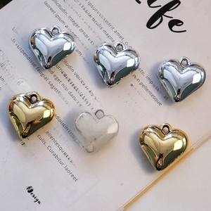 Macro view of metallic heart pendants in gold and silver finish with hanging rings