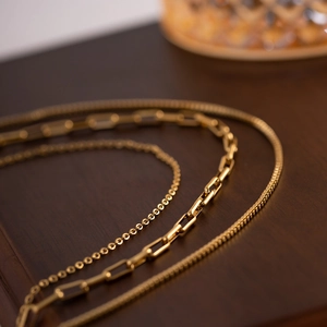 Three-layer 18K gold plated stainless steel necklace featuring varied chain link designs
