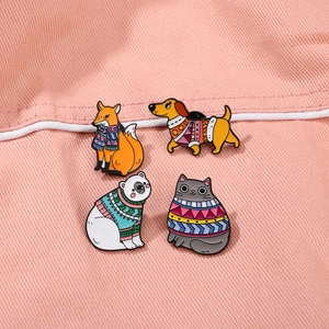 Cartoon animal enamel pins set featuring a fox, dachshund, bear and cat in winter sweaters