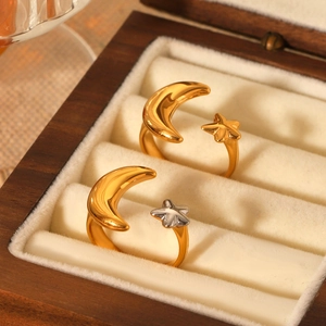 Two-tone stainless steel open ring with gold and silver stars and moon on velvet box