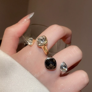 Macro shot of open rings with square zircon stones in gold and silver finish