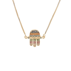 Detail of gold Hamsa hand pendant with colorful zircons and engraved MAMA lettering