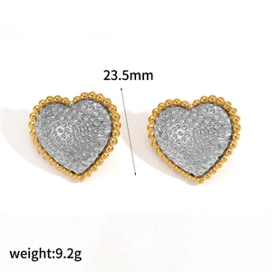 Detail view of heart stud earrings with gold beaded edges and silver hammered texture