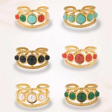 Detail of adjustable gold rings with five colorful beads in peacock green and turquoise