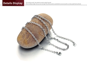Detailed macro view of thin silver stainless steel O-chain necklace with lobster clasp