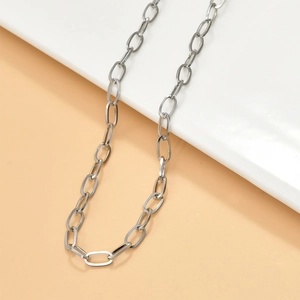 Detail view of silver O-chain necklace links on neutral background for DIY jewelry