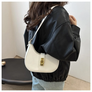 Detailed view of white crescent shoulder bag featuring a gold metal twist lock buckle
