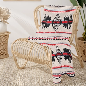 Detail showing the Southwestern tribal geometric pattern on a soft flannel sofa throw