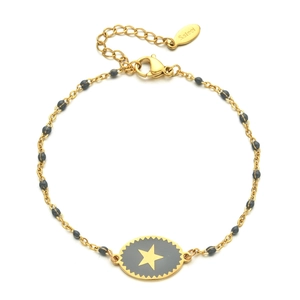 Detailed view of golden stainless steel star bracelet with black beads and lobster clasp