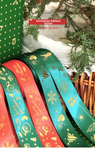 Detail of Christmas ribbons with gold foil reindeer and snowflake prints on satin fabric