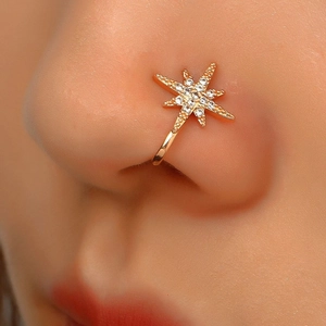 Close-up of golden S925 sterling silver star nose cuff with sparkling rhinestones