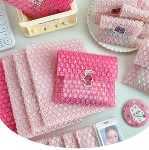 Detail of pink heart-shaped bubble mailers with protective cushioning for gift packaging