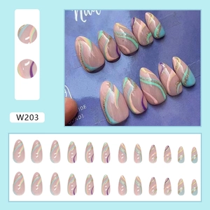 Detail view of almond shape press on nails with colorful swirls and gold glitter accents