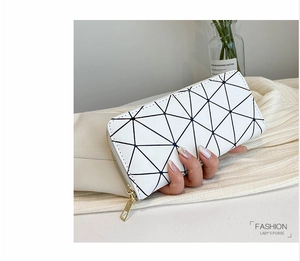 Detail of laser geometric triangle patchwork women's long wallet on white fabric